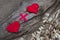 Heart plus heart. Two red toy hearts on natural burlap background, lovers together and forever idea