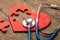 Heart puzzle red and stethoscope on wooden background. Concept diagnosis and treatment of heart disease, medical insurance
