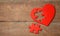 Heart puzzle red on a wooden background. Concept second half of the heart in love for Valentine`s Day or illness