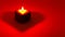 Heart on red background. A lighted candle in the shape of a heart. Blank for postcards. Greeting card on happy women`s day,