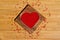 Heart from red beads in wooden heart-shaped box