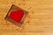 Heart from red beads in wooden heart-shaped box