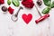 Heart, red rose, chocolate , key and corkscrew on white wooden, love background