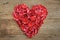 Heart of red rose petals on wooden. Valentine\'s Day, anniversary