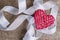 Heart and ribbon on burlap Background. Wedding Love Concept