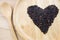 Heart rice berry in wooden bowls with spoon on wooden background