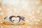 Heart ring on the floor with golden bokeh on background