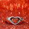 Heart ring on the floor with red bokeh on background