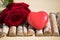 Heart with rose, wooden background