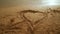 Heart sand. Heart draw on sand. Heart shape on sand background