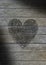 Heart scribbled on a gray weathered wood