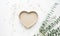 Heart shape box with baby eucalyptus branch on white table