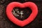 Heart shape on brown background with rosary beads and Jesus Christ holy cross crucifix. Love, pray and hope concept with rosary.