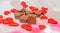 Heart shape chocolate with red hearts, Valentines Day sweets, pink bokeh background