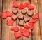 Heart shape chocolate with red hearts, Valentines Day sweets, wood background