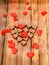 Heart shape chocolate with red hearts, Valentines Day sweets, wood background