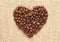 Heart shape coffee beans on sacking