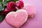 Heart shape cookies decorated as pink ladies dresses with bouquet of pink roses