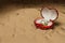 the heart shape diamond ring in a red box on a night sand beach background