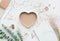 Heart shape with dry branch flower and notepaper on white