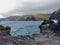 Heart shape geological formation naturally occurring in lava rock wall at Nakalele in Hawaii, USA, with ocean and Maui Mountains i