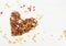 Heart shape granola on white wooden background