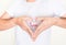 Heart shape hands on left side chest with love inside