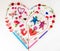 Heart shape lat design using office and art supplies, petals, butterfly, red head set and gender neutral characters with