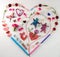 Heart shape lat design using office and art supplies, petals, butterfly, red head set and gender neutral characters with