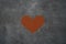 Heart shape made of grinded coffee or cocoa powder on concrete background