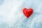 Heart shape made from red glass in the cold white snow  hot love symbol for seasonal holidays like valentines day or chrismas