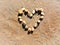 Heart Shape Made From Rock Pebbles In The Sand