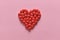 A heart shape of medicine pills on pink background. Concept of Valentine`s Day or pharmacy, Medical.