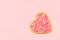 Heart shape pink cookie on a pink background