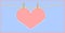 Heart shape pink paper hanging with clothespin