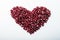 Heart shape pomegranate seeds on white background.  Valentines helthy love concept