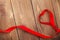 Heart shape ribbon over wood valentines day background