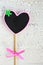 The heart shape small black board or chalkboard over old white w