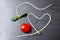 Heart shape of spaghetti and grape tomatoes on Black pan