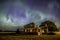 Heart-shaped Aurora Borealis over historic Goodwin House at the Saskatchewan Landing in Saskatchewan, Canada