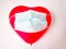 a a heart-shaped balloon wearing a mask,