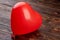 Heart shaped balloon on wooden background.