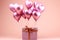 Heart shaped balloons with gift boxes on pink background, celebrating mothers day and valentines day