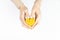 Heart shaped beeswax candle in female hands on white background
