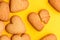 Heart-shaped biscuit cookies on yellow