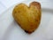 Heart-shaped boiled potatoes arranged on a white plate . Beautiful yummy german foods in the form of a heart . Fantastic gourmet