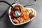 Heart shaped bowl with dried fruits, nuts and stethoscope