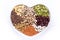 Heart-shaped bowl full of types of dry legumes