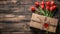 A heart-shaped box sits next to a vibrant bouquet of red tulips on a wooden table, creating a lovely display