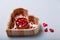 Heart shaped box with small wooden decorative pins with tiny red ladybugs for handwork, handmade decorations, leisure time